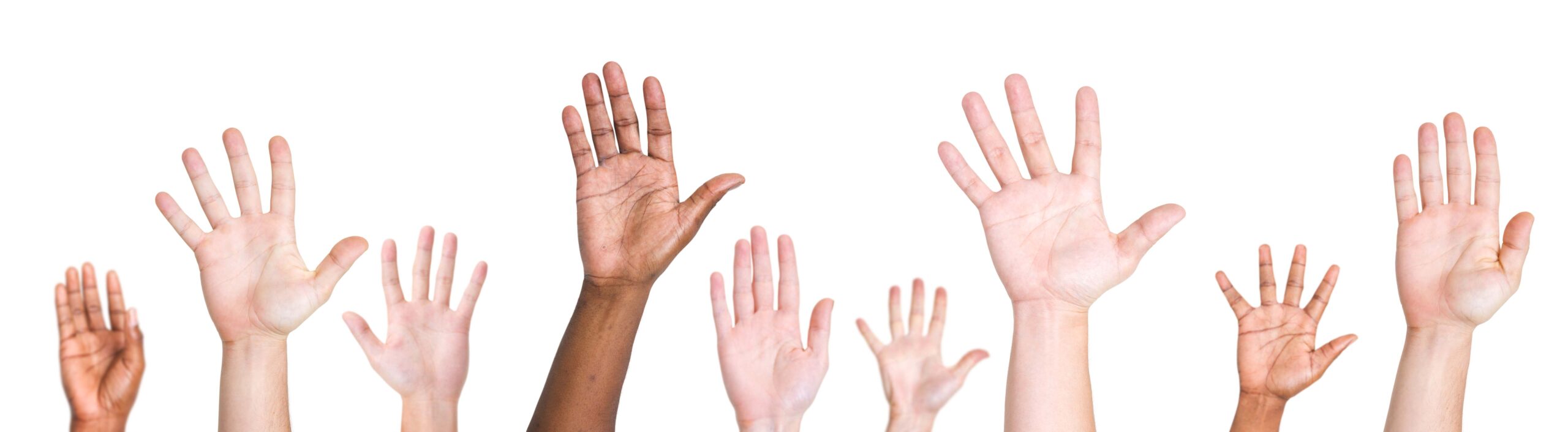diverse hands raised in air