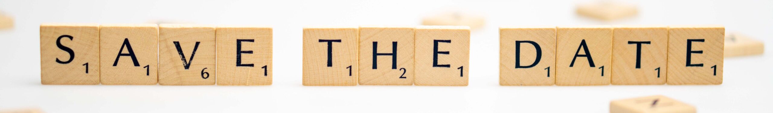 the word save the date spelled out in scrabble tiles